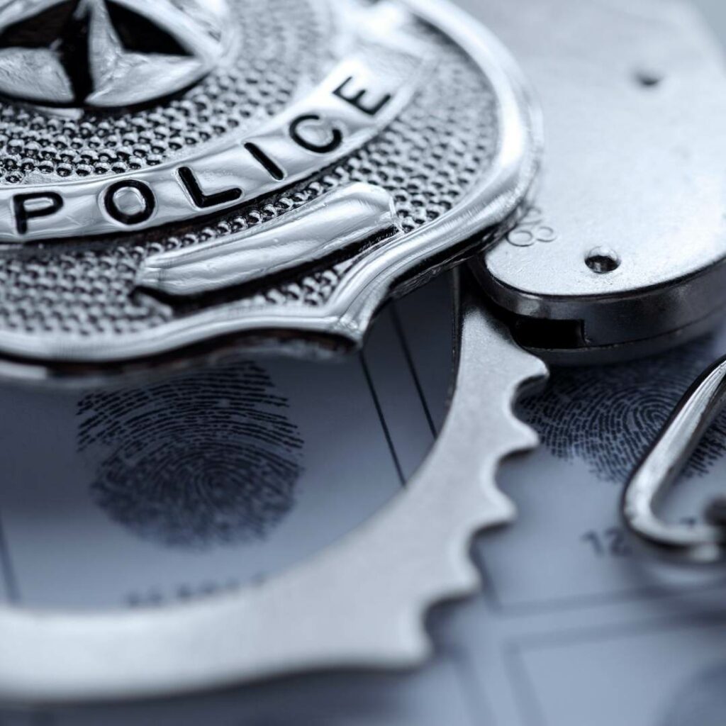 Police Badge With Handcuffs - Donahue Law Firm