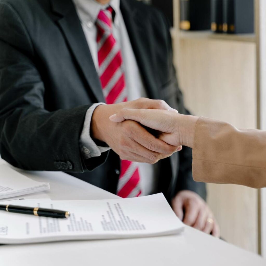Man Shaking Woman'S Hand - Donahue Law Firm