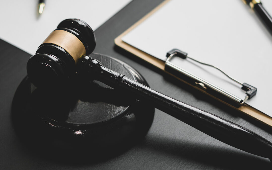 a gavel on a stand next to a clipboard